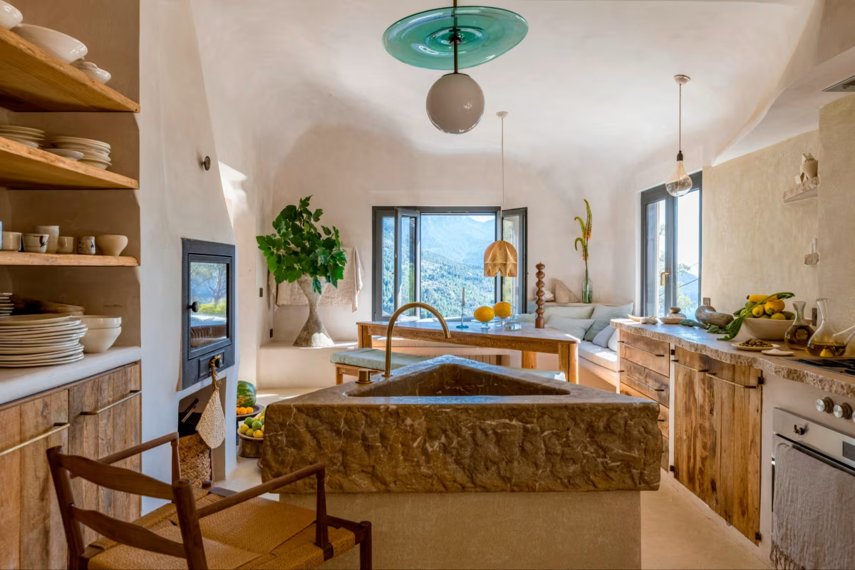 Una lámpara colgante, hecha por un soplador de vidrio local, cuelga sobre el fregadero triangular de piedra caliza en la cocina.