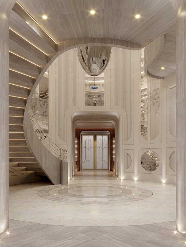 El hall de ingreso marca el tono de la casa, con escaleras curvas, mármol claro y una arquitectura interior de gran escala.